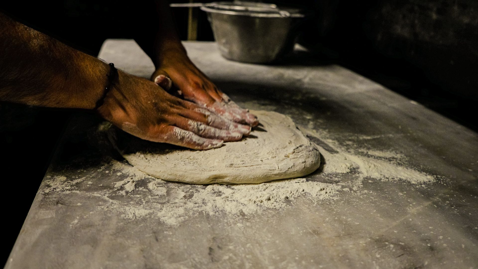 Pizzaiolo knetet Teig von Hand